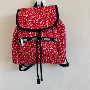 LeSportsac Small Edie Backpack in red  with a white and blue floral pattern.
